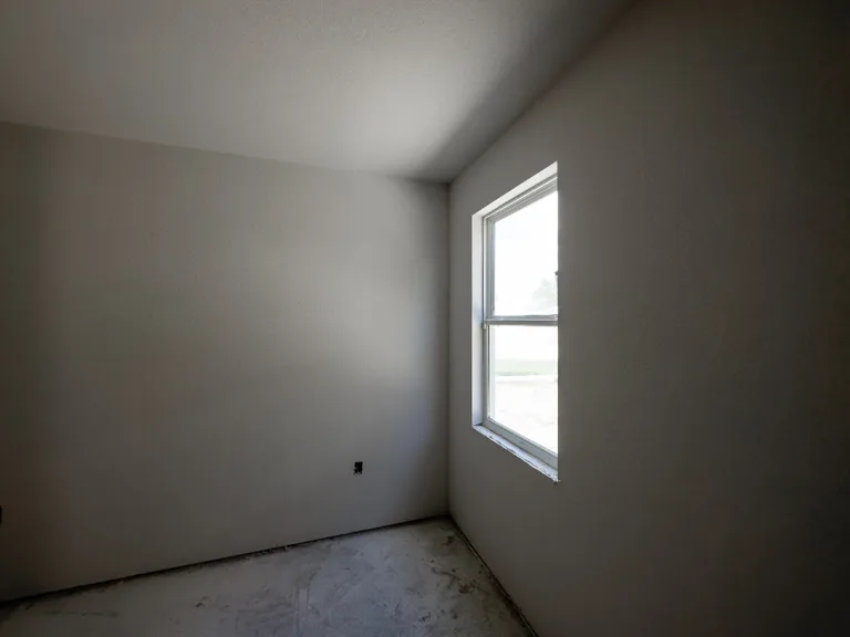 A room mid-renovation, bare walls and floor