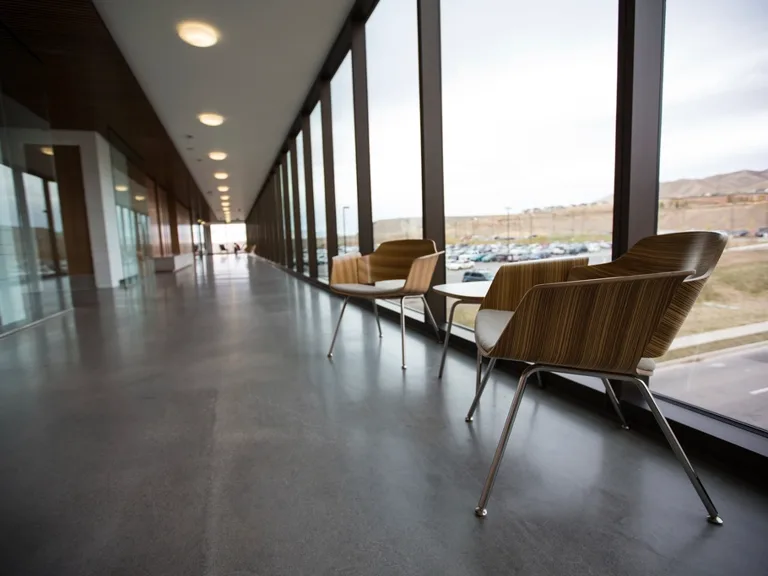 A glass-walled office corridor